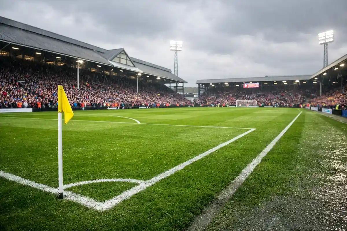 Estadio de f&uacute;tbol ingl&eacute;s con c&eacute;sped verde intenso y gradas repletas de seguidores